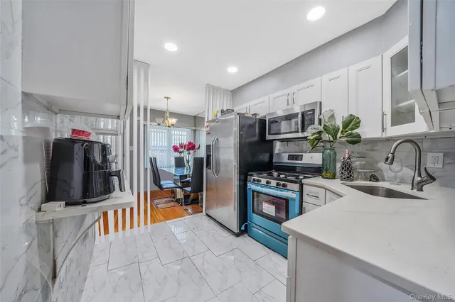 a kitchen with appliances a sink and cabinets