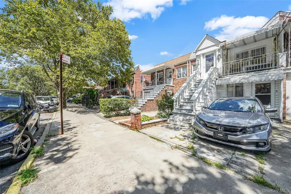 a car parked in front of a brick house