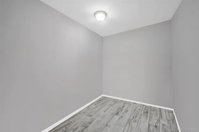a bedroom with a bed and flat tv screen on a dresser