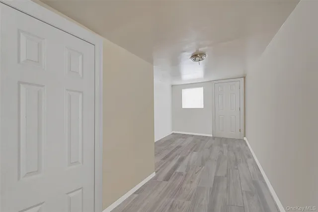 a view of an empty room and wooden floor