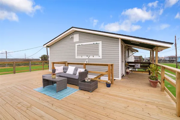 a view of a terrace with wooden floor and furniture
