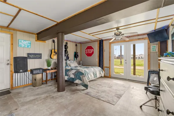 a bedroom with bed and glass door