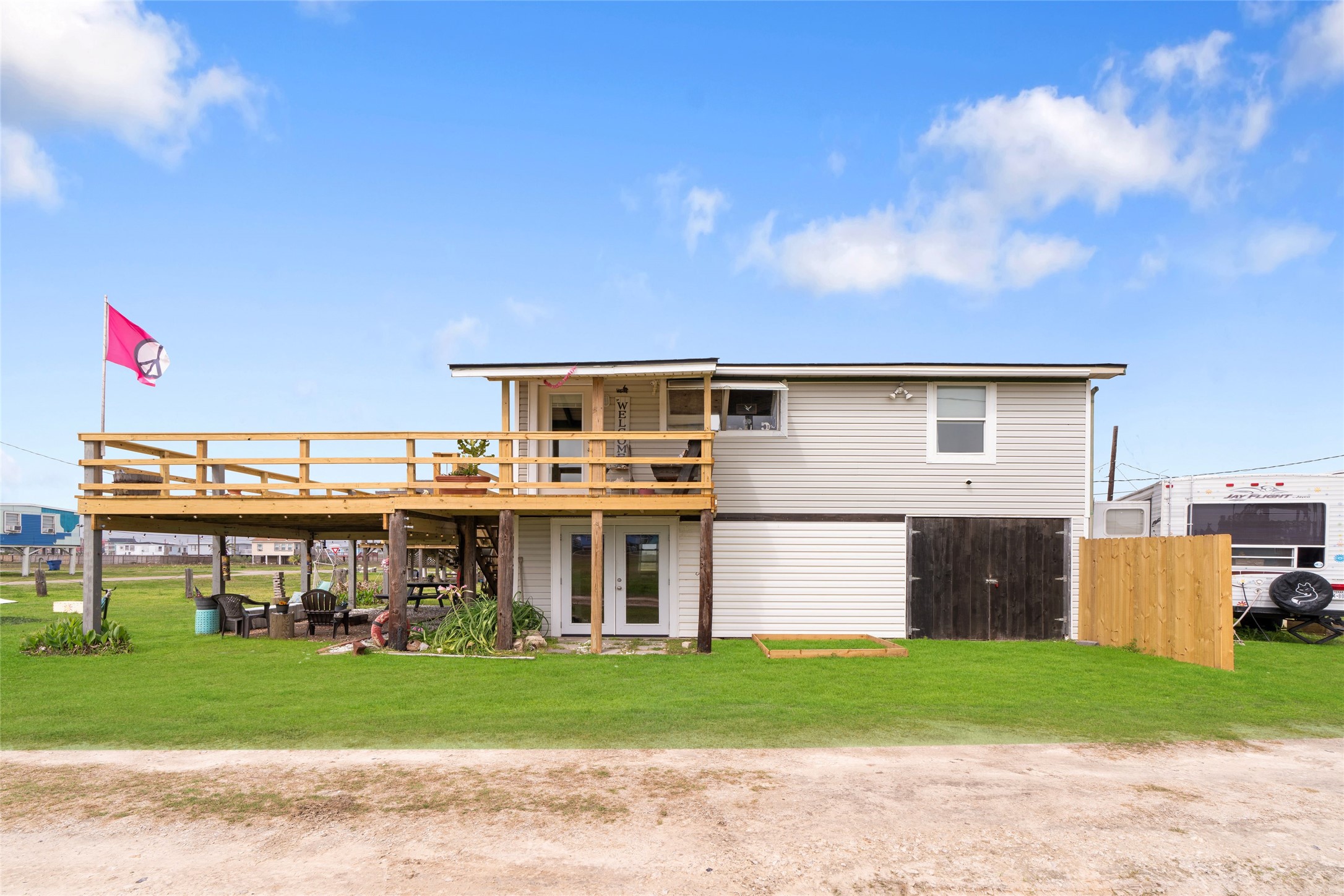 512 Caisson Street Surfside Beach, TX 77541 - Photo 2 of 29 a front view of a house with a yard and a garage