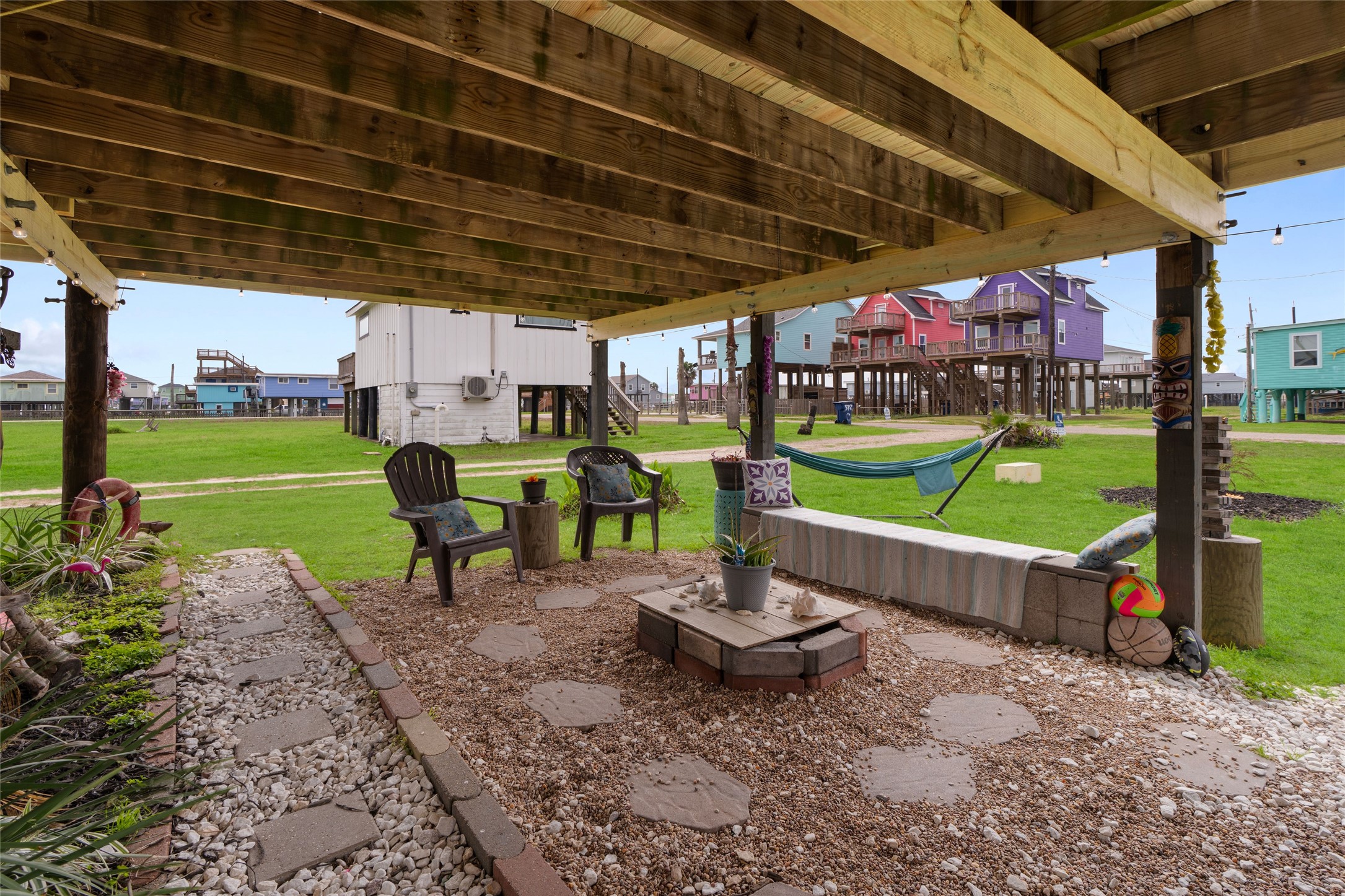 512 Caisson Street Surfside Beach, TX 77541 - Photo 24 of 29 a view of a chairs and table in backyard