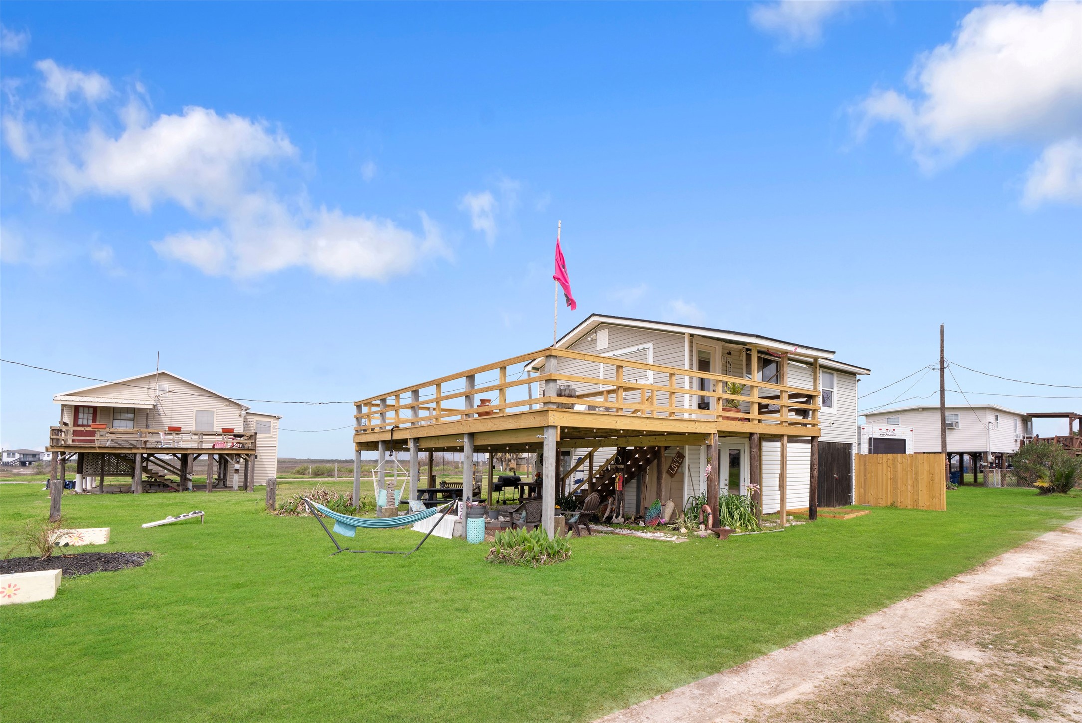 512 Caisson Street Surfside Beach, TX 77541 - Photo 26 of 29 a view of a big house with a big yard and large trees