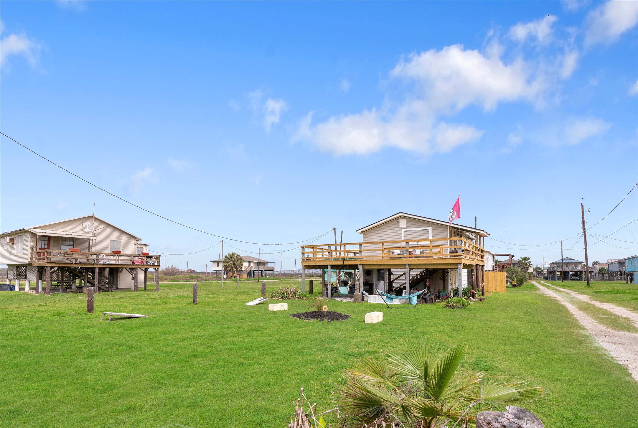 512 Caisson Street Surfside Beach, TX 77541 - Photo 28 of 29 a view of a big house with a big yard and large trees