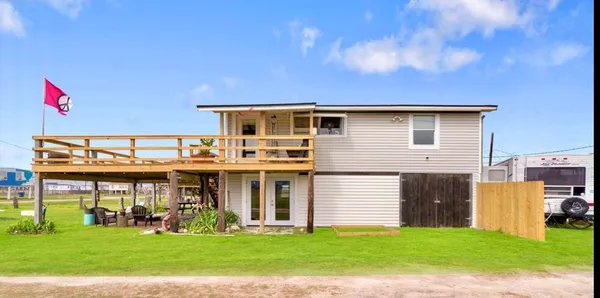 a view of a house with a yard and sitting area