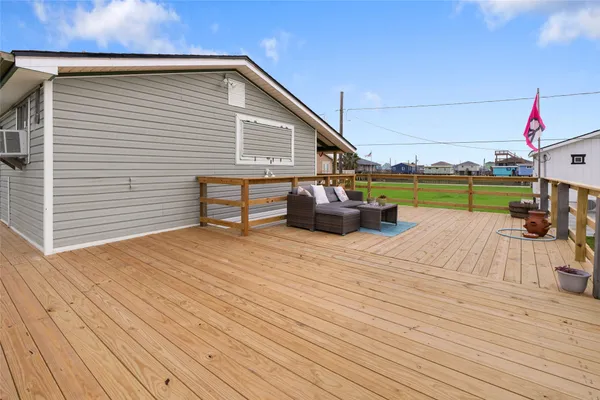 a view of a terrace with wooden floor and outdoor seating
