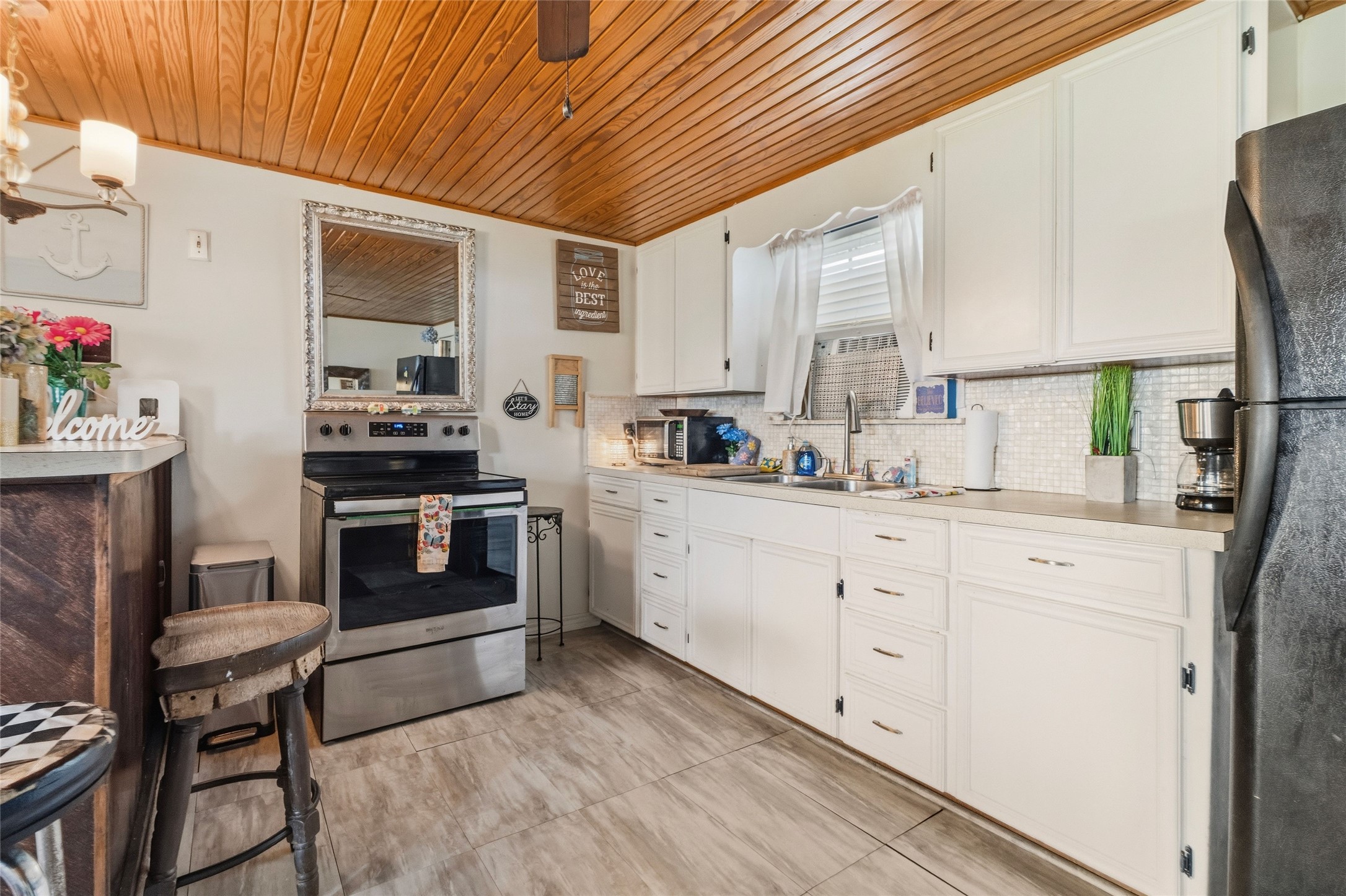 512 Caisson Street Surfside Beach, TX 77541 - Photo 9 of 29 a kitchen with granite countertop a sink cabinets stainless steel appliances and a window