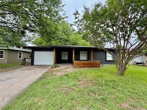 a front view of house with yard and trees