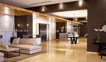 60 Southwest 13th Street, Unit 1219 Miami, FL 33130 - Photo 12 of 15 a living room with furniture and a flat screen tv