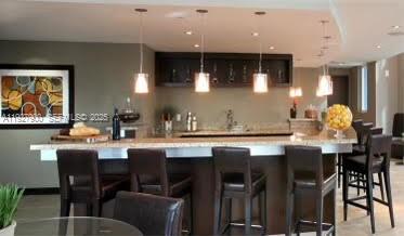 60 Southwest 13th Street, Unit 1219 Miami, FL 33130 - Photo 13 of 15 a kitchen with a table and chairs in it