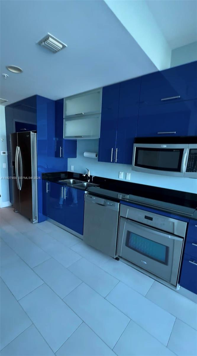60 Southwest 13th Street, Unit 1219 Miami, FL 33130 - Photo 4 of 15 a kitchen with a sink and cabinets