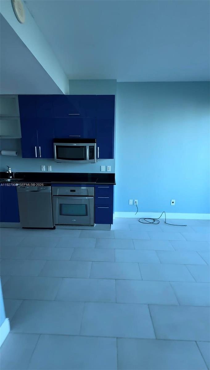 60 Southwest 13th Street, Unit 1219 Miami, FL 33130 - Photo 5 of 15 a view of kitchen cabinets and wooden floor