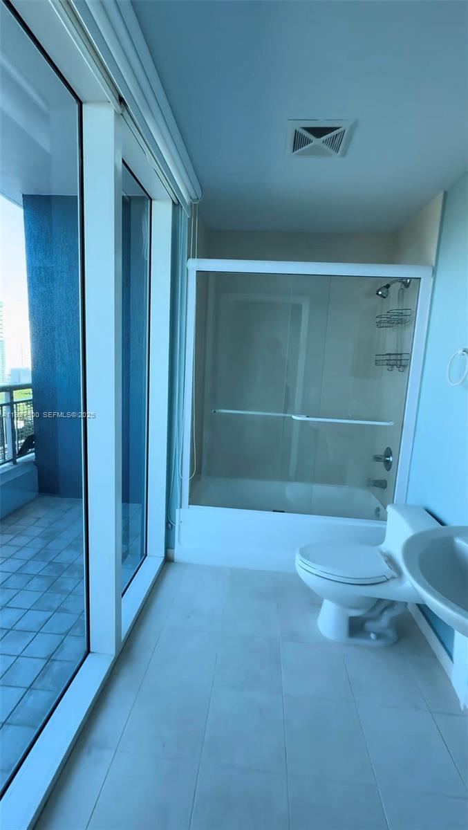 60 Southwest 13th Street, Unit 1219 Miami, FL 33130 - Photo 7 of 15 a view of empty room with wooden floor and fan