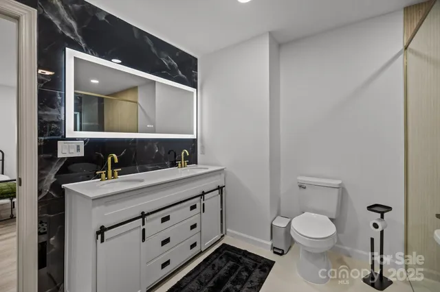 a bathroom with a toilet sink and mirror