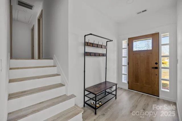 a view of a livingroom with wooden floor and white walls