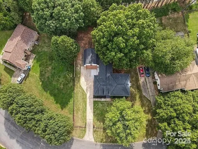 an aerial view of a house with a yard and plants