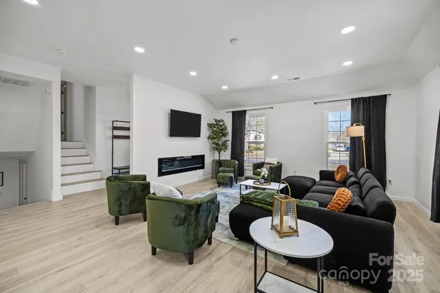 a living room with fireplace furniture and a wooden floor