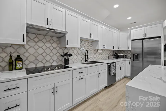 a kitchen with white cabinets and white appliances