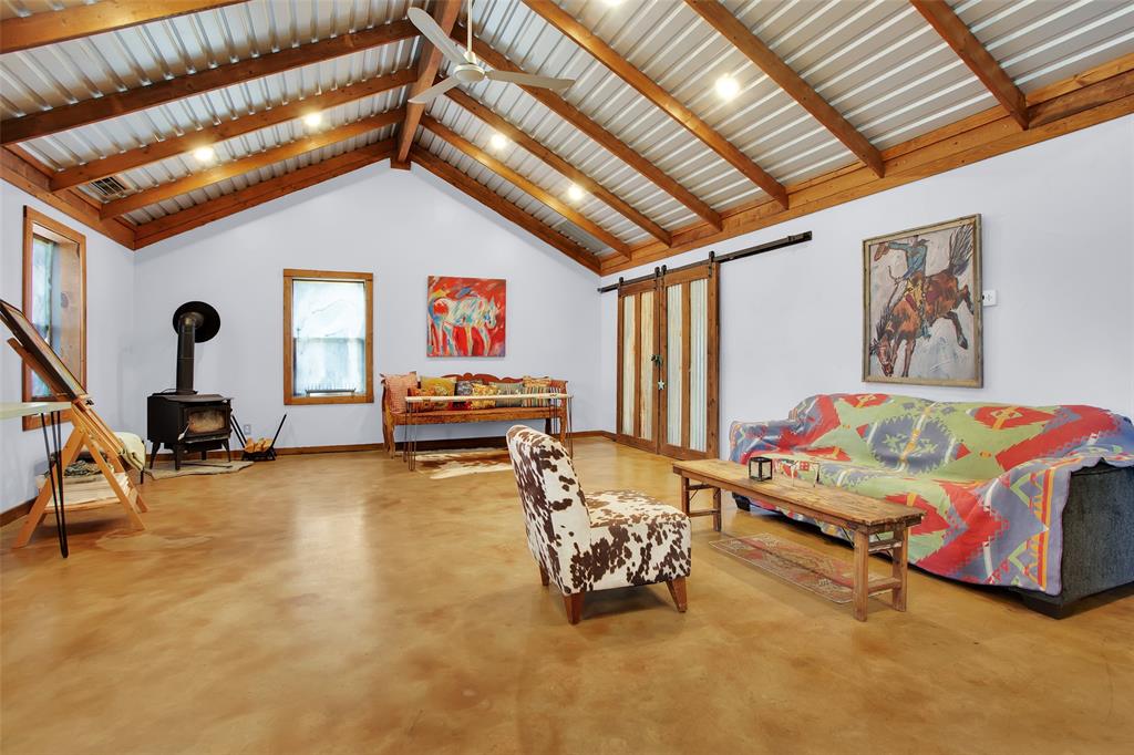 855 Buck Creek Road Tioga, TX 76271 - Photo 11 of 27 a bedroom with furniture and a chandelier