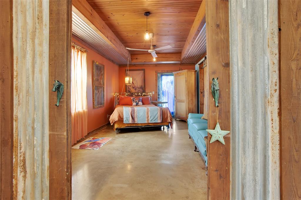 855 Buck Creek Road Tioga, TX 76271 - Photo 12 of 27 a bed room with a bed and a chandelier