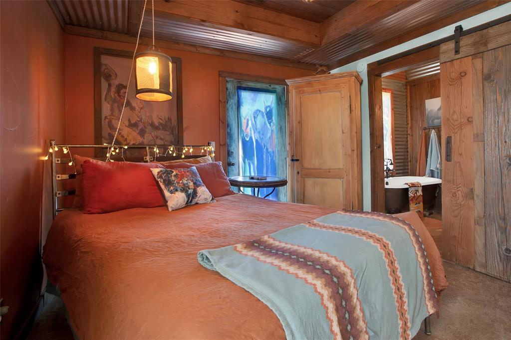 855 Buck Creek Road Tioga, TX 76271 - Photo 14 of 27 a bedroom with a bed and a mirror
