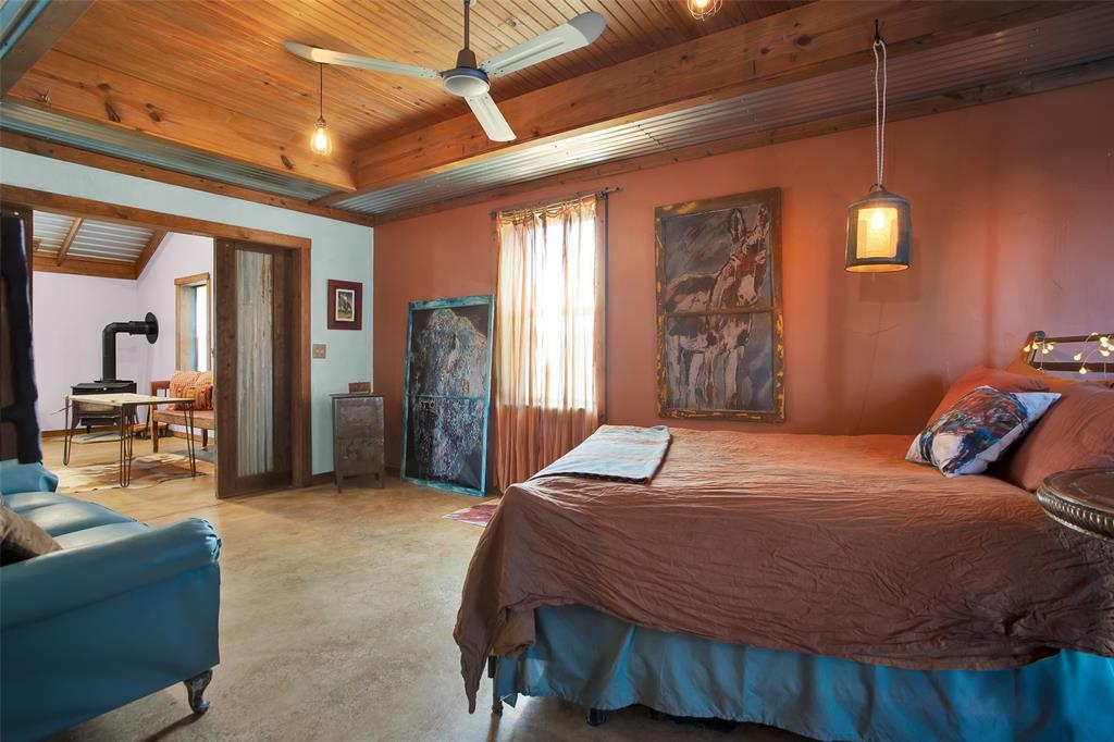 855 Buck Creek Road Tioga, TX 76271 - Photo 15 of 27 a bed sitting in a spacious bedroom next to a window