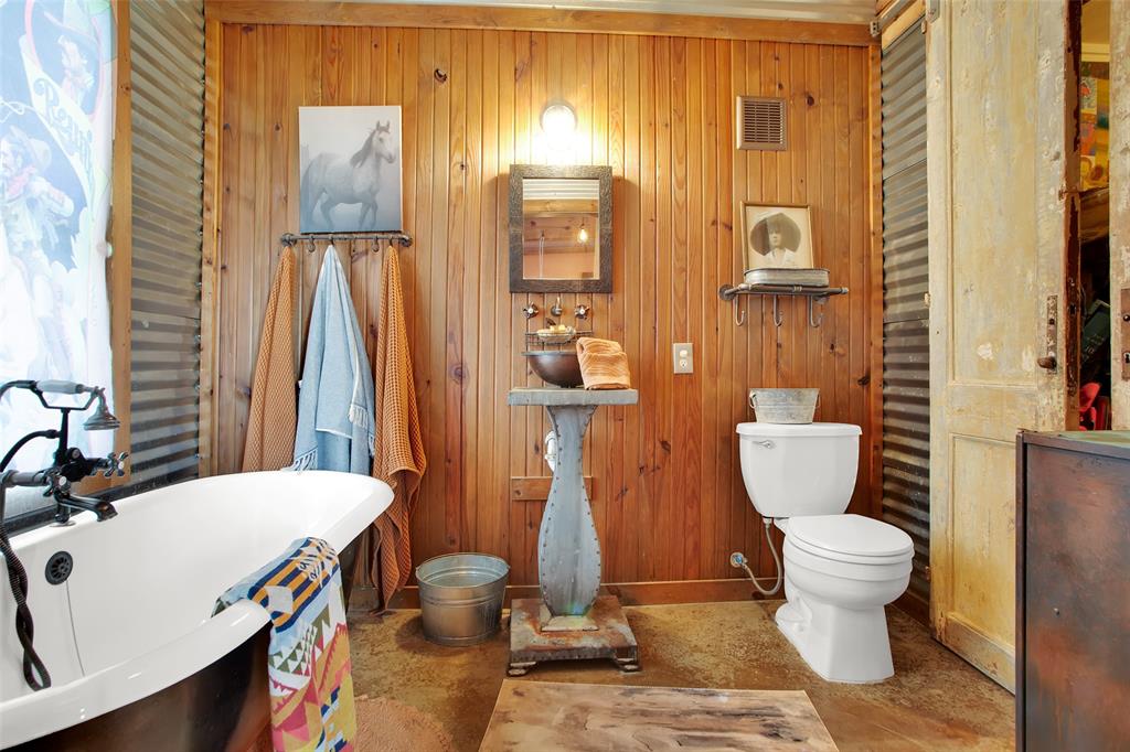 855 Buck Creek Road Tioga, TX 76271 - Photo 18 of 27 a bathroom with a toilet sink and shower curtain