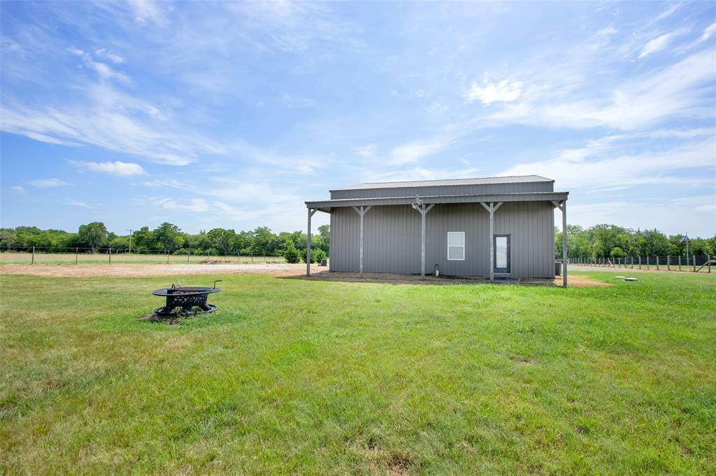 855 Buck Creek Road Tioga, TX 76271 - Photo 23 of 27 a backyard of a house with lots of green space and lake view