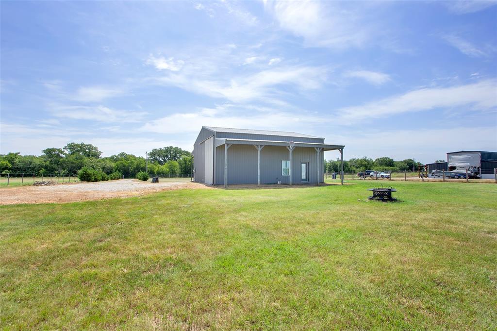 855 Buck Creek Road Tioga, TX 76271 - Photo 24 of 27 a view of a house with a big yard and large tree
