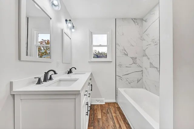 a bathroom with a sink a bathtub and a shower