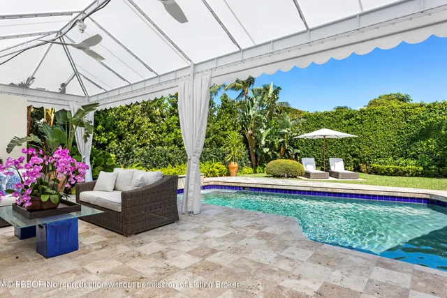 a view of a backyard with furniture and a small yard