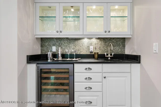 a living room with furniture and flowers