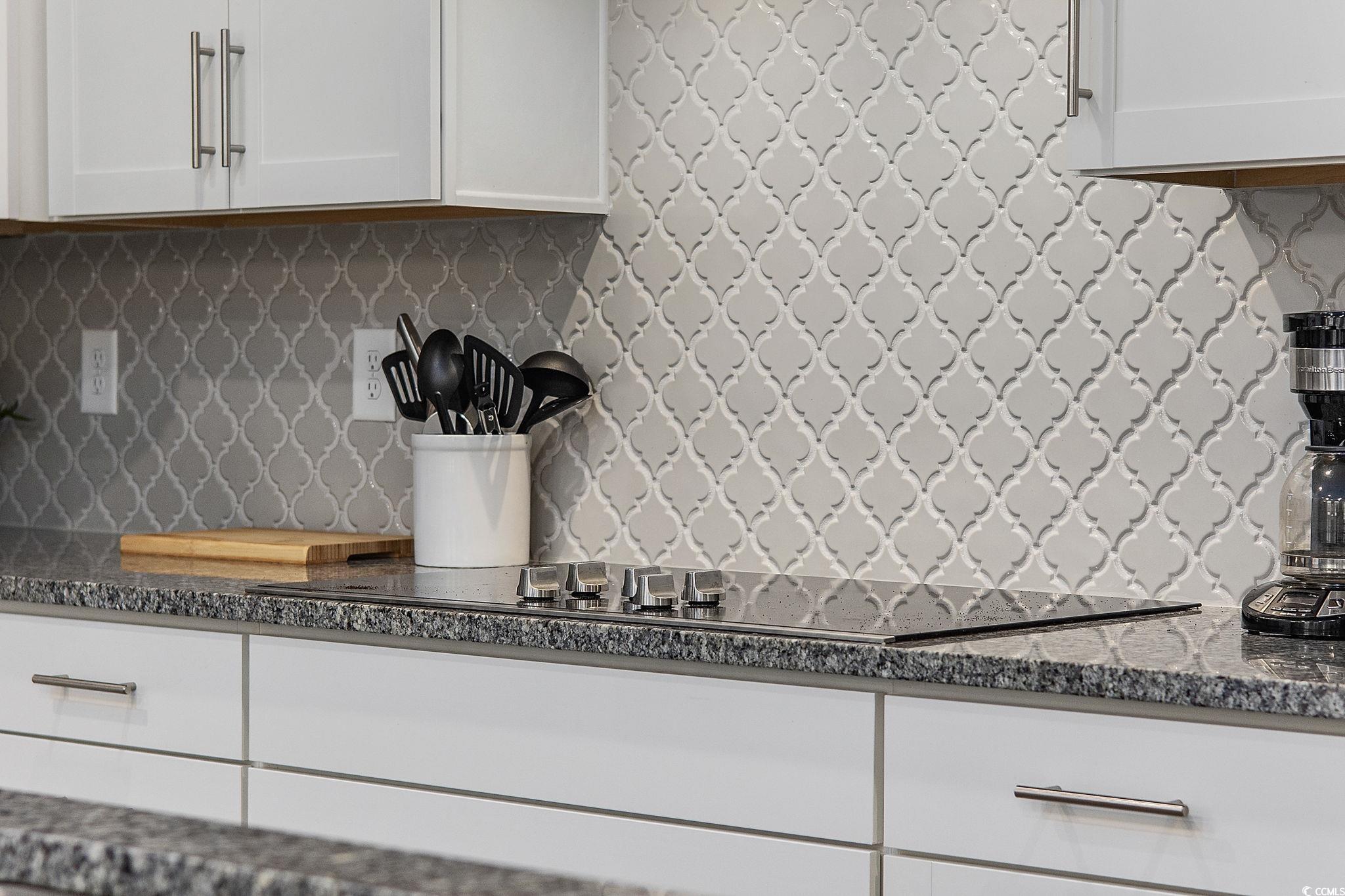 5130 Double Eagle Way North Myrtle Beach, SC 29582 - Photo 13 of 39 Kitchen with decorative backsplash, white cabinetry, dark stone countertops, and black electric stovetop