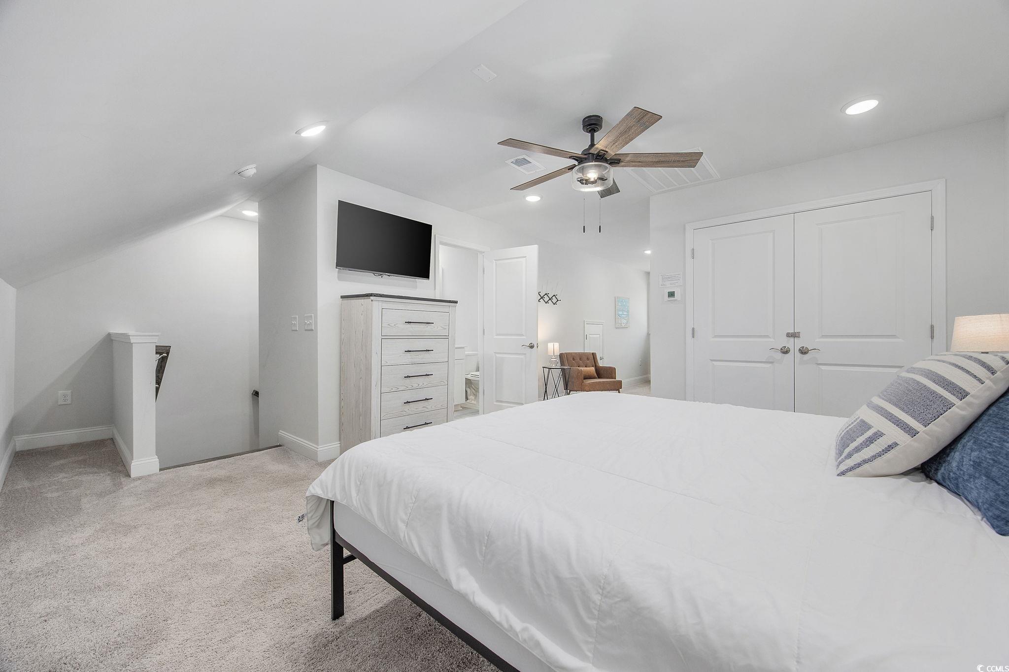 5130 Double Eagle Way North Myrtle Beach, SC 29582 - Photo 19 of 39 Bedroom featuring light carpet, ceiling fan, vaulted ceiling, recessed lighting, and a closet