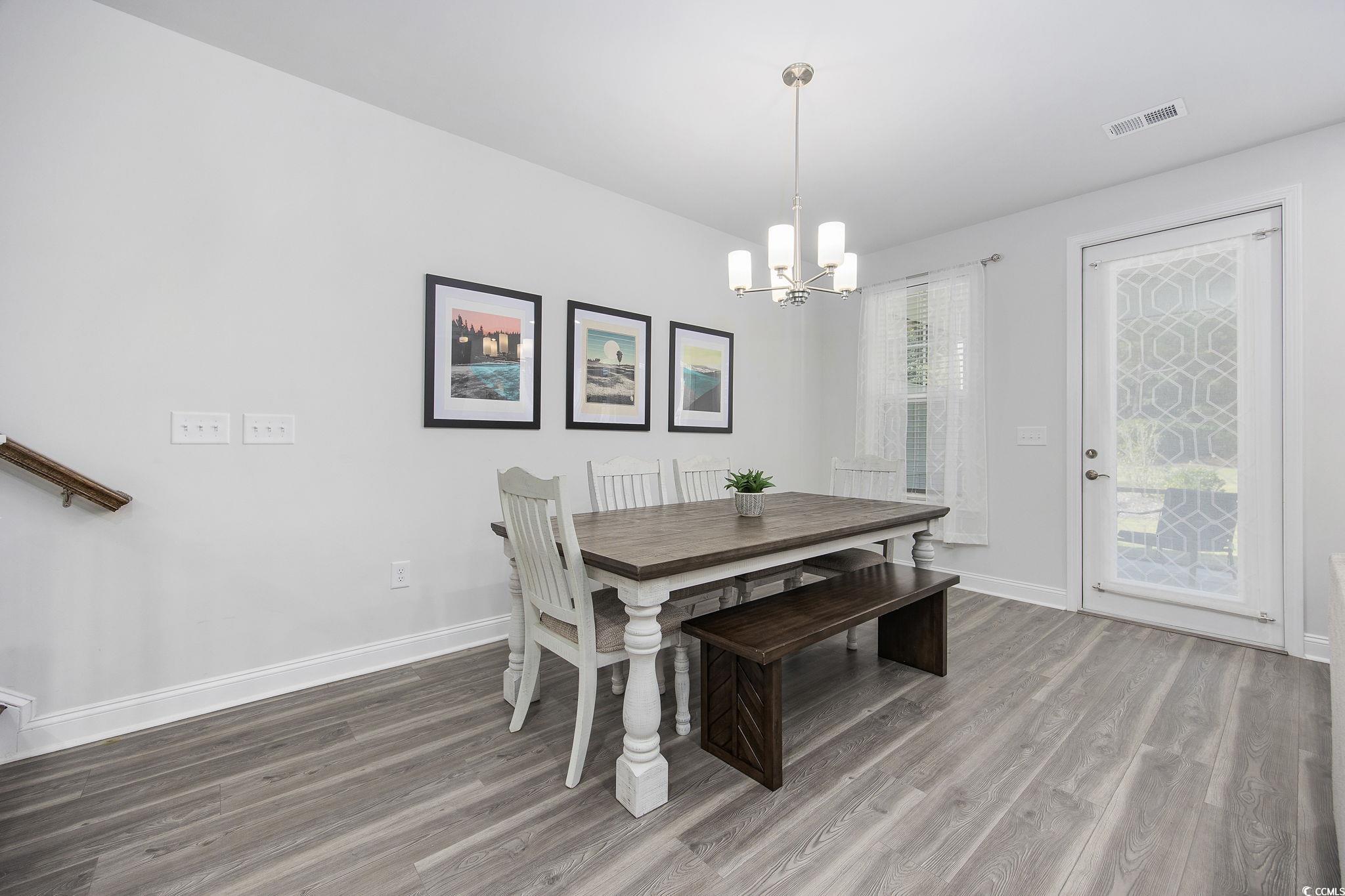 5130 Double Eagle Way North Myrtle Beach, SC 29582 - Photo 31 of 39 Dining space featuring light wood-type flooring and a chandelier