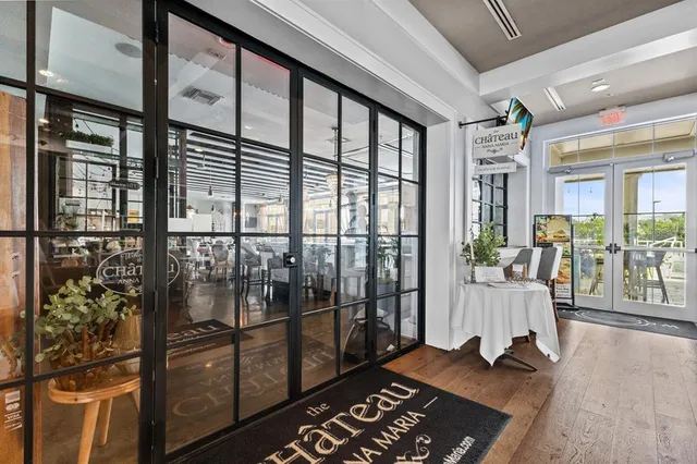 a dining room with furniture potted plants and a painting
