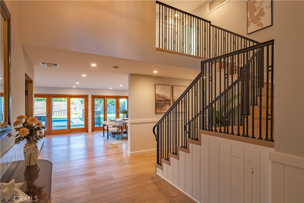 556 Camillo Road Sierra Madre, CA 91024 - Photo 16 of 52 a view of staircase with lots of frames and frames on wooden floor