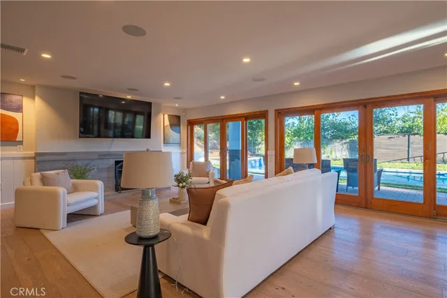 a living room with couches and a flat screen tv