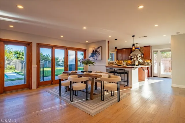 a living room with furniture a wooden floor and a large window