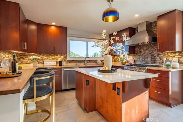 a kitchen with stainless steel appliances a sink stove and cabinets