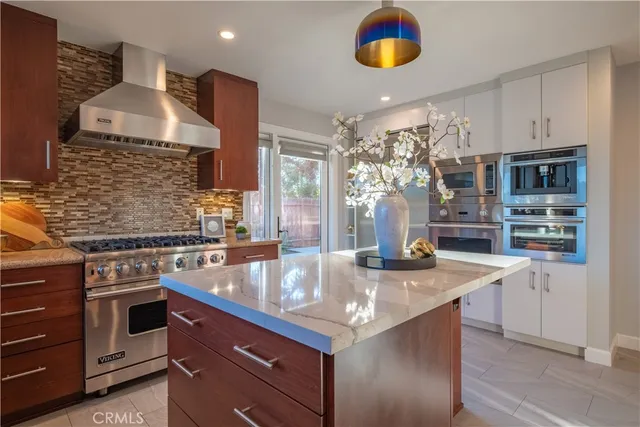 a kitchen with stainless steel appliances granite countertop a sink and a stove