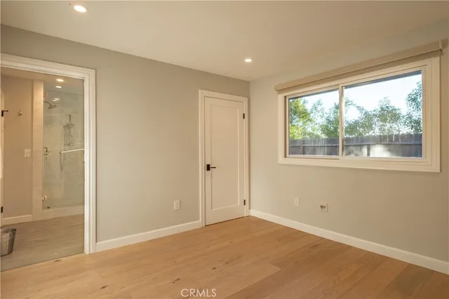 a bedroom with a bed a desk and chair