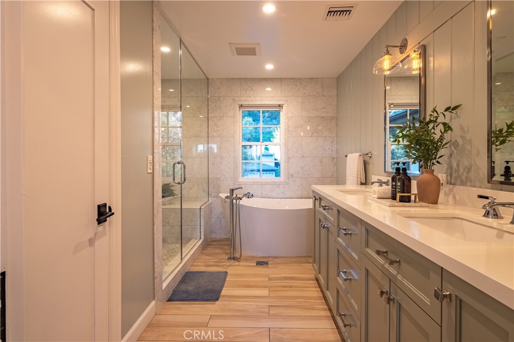 556 Camillo Road Sierra Madre, CA 91024 - Photo 42 of 52 a bathroom with a double vanity sink a large mirror and shower