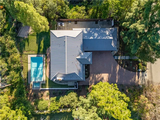 a front view of a house with a yard and a garden