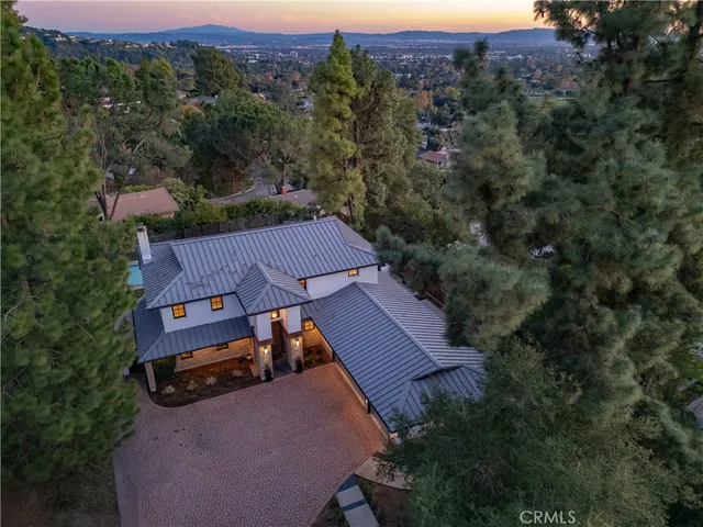 an aerial view of a house with a yard basket ball court and outdoor seating