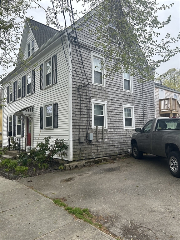 20 William Street Fairhaven, MA 02719 - Photo 3 of 7 a view of a house with a yard and a car parked in front of it
