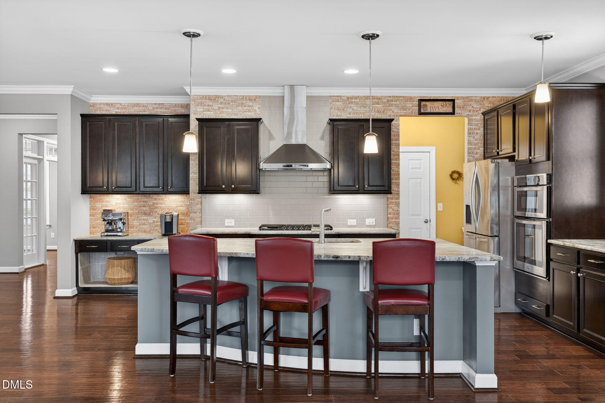 8001 Hergety Drive Raleigh, NC 27603 - Photo 12 of 52 a kitchen with stainless steel appliances granite countertop a stove top oven a refrigerator a sink and chairs