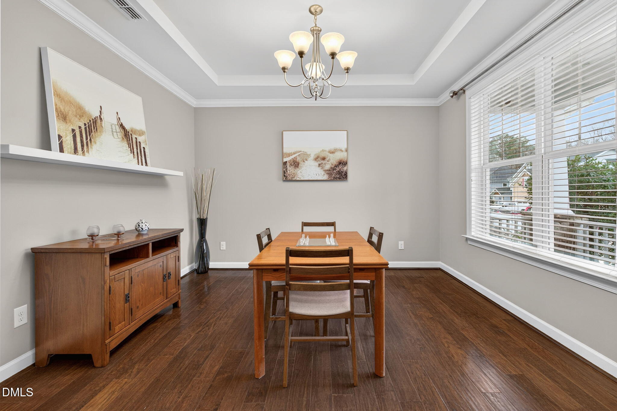 8001 Hergety Drive Raleigh, NC 27603 - Photo 14 of 52 a view of a dining room with furniture a chandelier and wooden floor